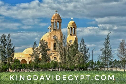 Exterior view of the Syrian Monastery in Wadi El Natrun, Egypt, showcasing its historic Coptic architecture and domes